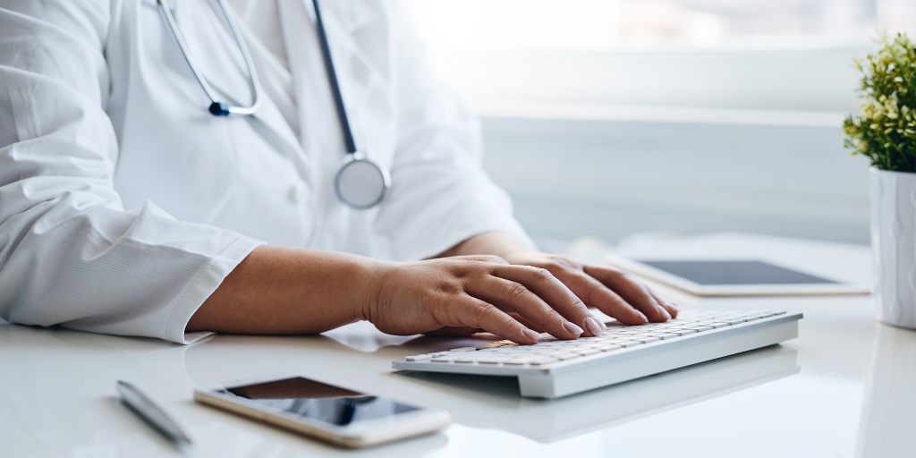 Physician typing on keyboard